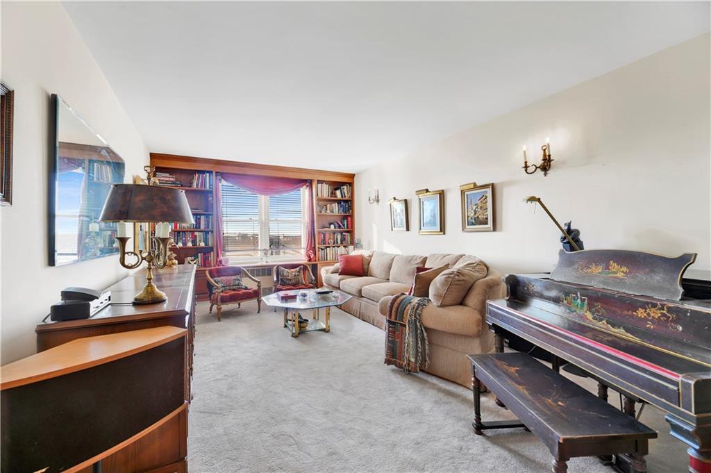131 74th Street, Unit 6J Brooklyn, NY 11209 - Photo 5 of 21 a living room with furniture fireplace and a large window