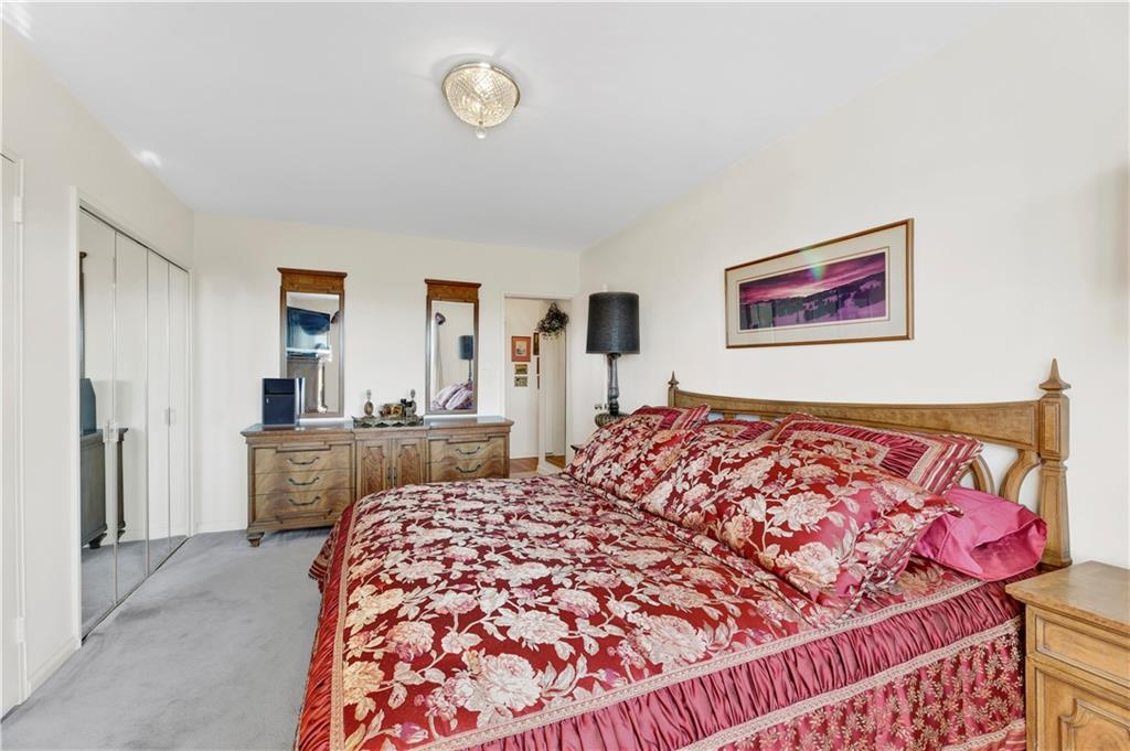 131 74th Street, Unit 6J Brooklyn, NY 11209 - Photo 8 of 21 a bed sitting in a bedroom next to a window with a dresser