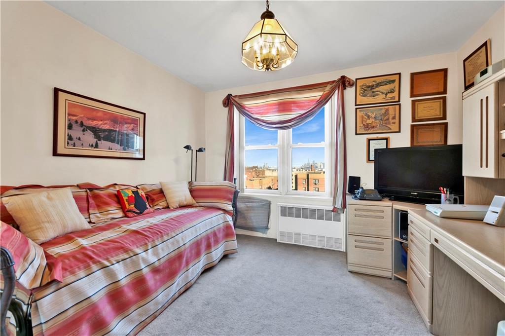 131 74th Street, Unit 6J Brooklyn, NY 11209 - Photo 9 of 21 a bedroom with furniture and a flat screen tv