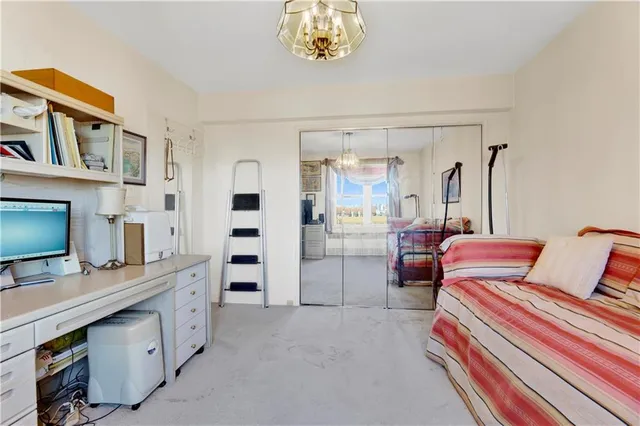 a bedroom with furniture and a flat screen tv