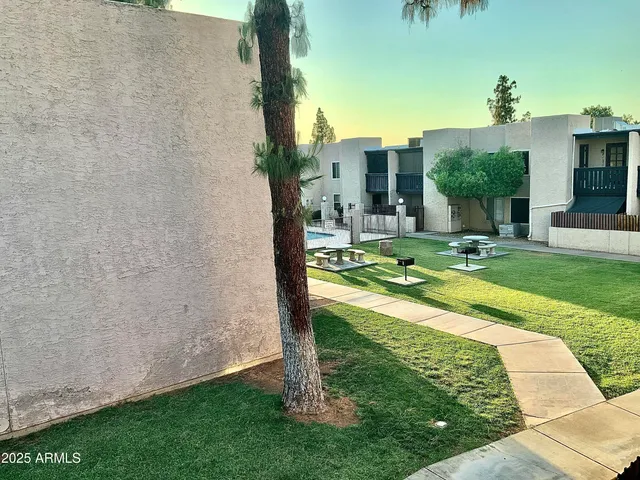 a view of a patio with a table and chairs