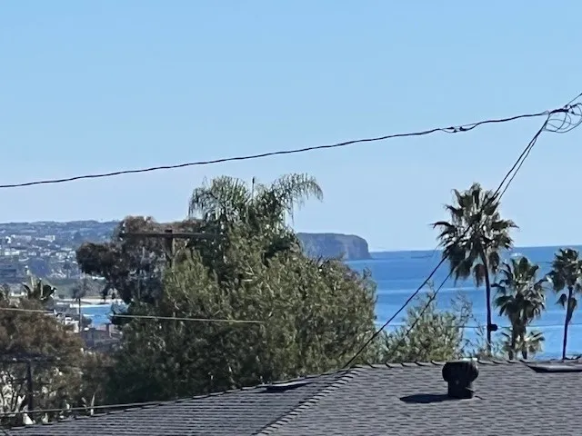 a view of kitchen with a refrigerator cabinets and wooden floor