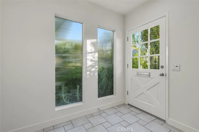 a living room with furniture a large window and a fireplace