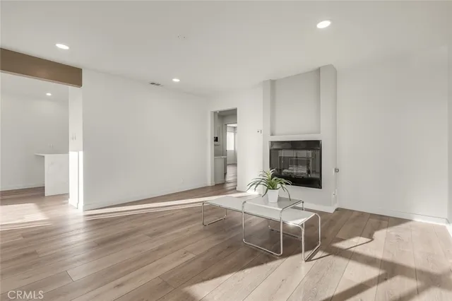 a view of a livingroom with a furniture window and wooden floor