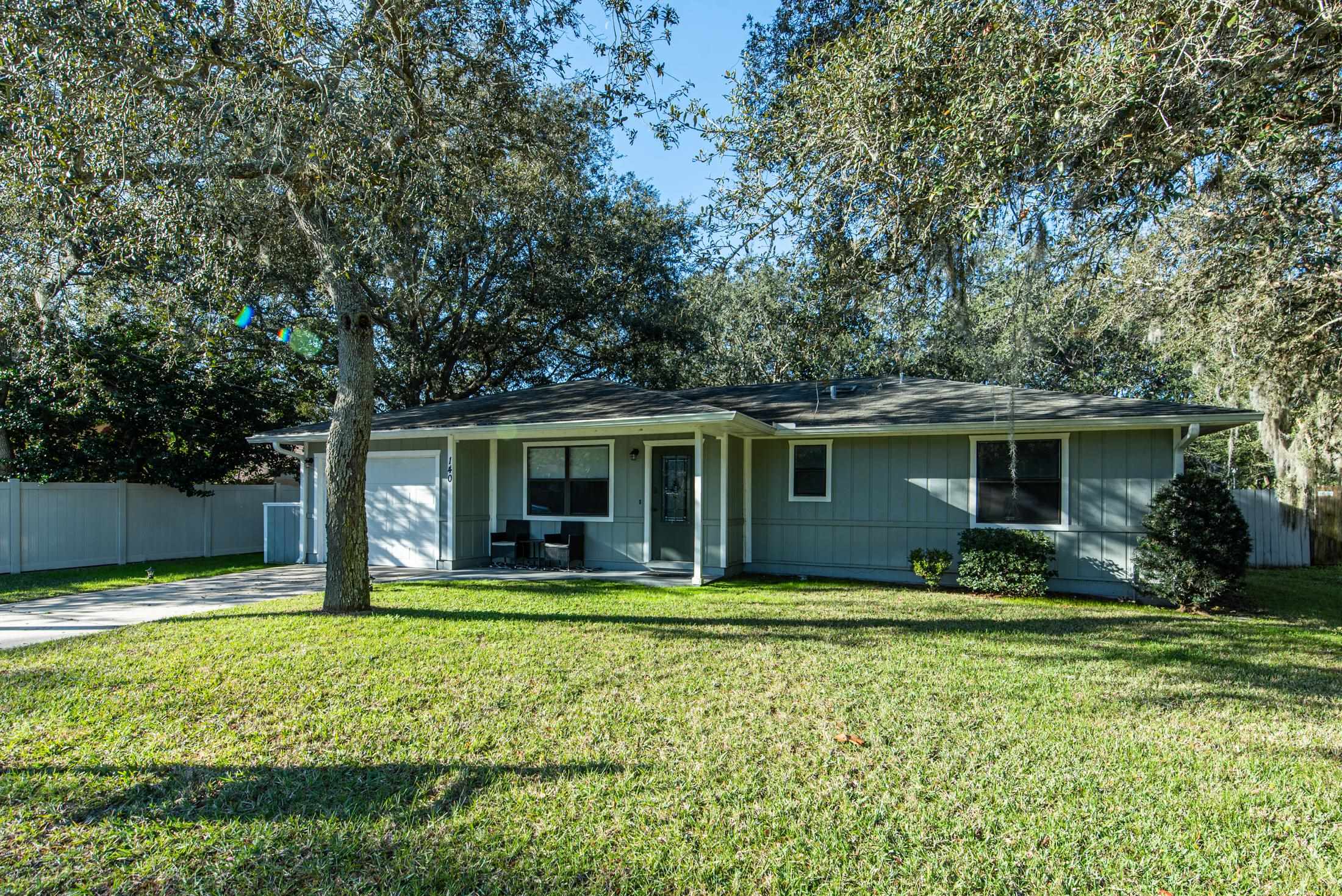 a view of a house with backyard sitting area and swimming pool