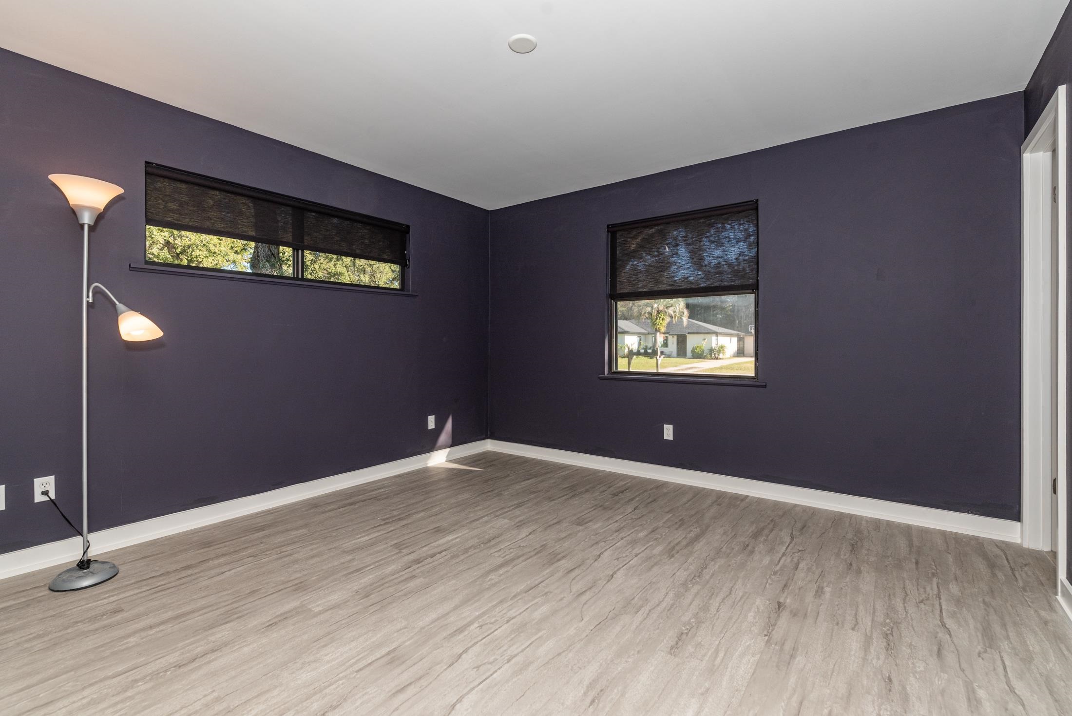 140 Orchis Road St. Augustine, FL 32086 - Photo 15 of 41 a view of an empty room with window and wooden floor