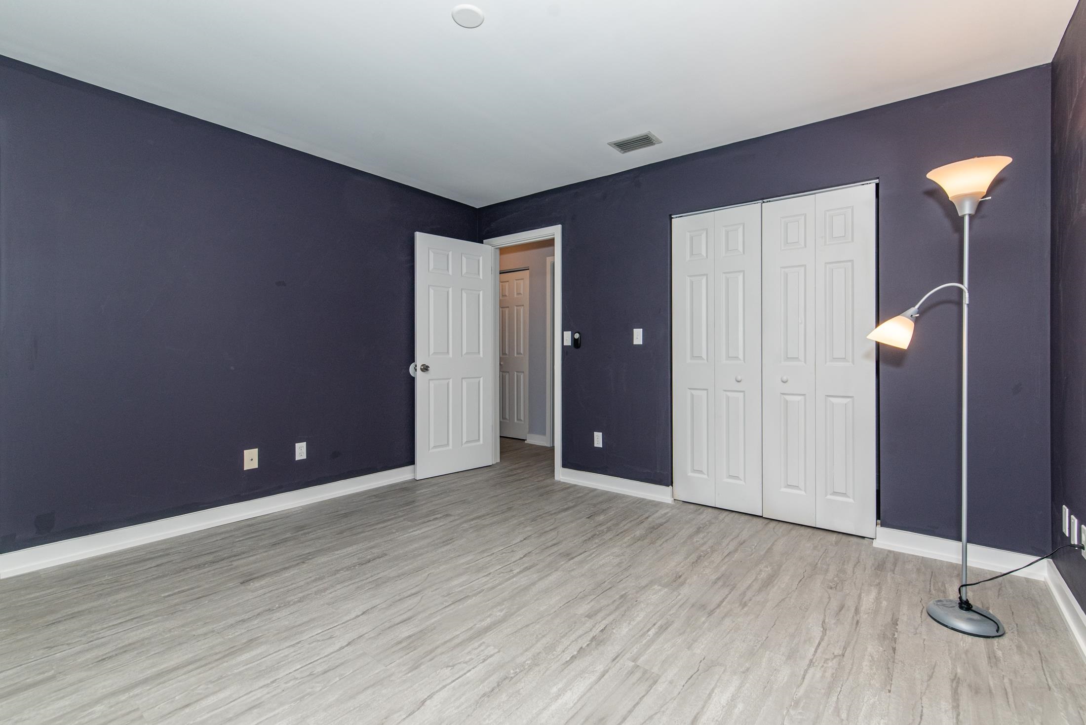 140 Orchis Road St. Augustine, FL 32086 - Photo 21 of 41 a view of an empty room with wooden floor and a mirror