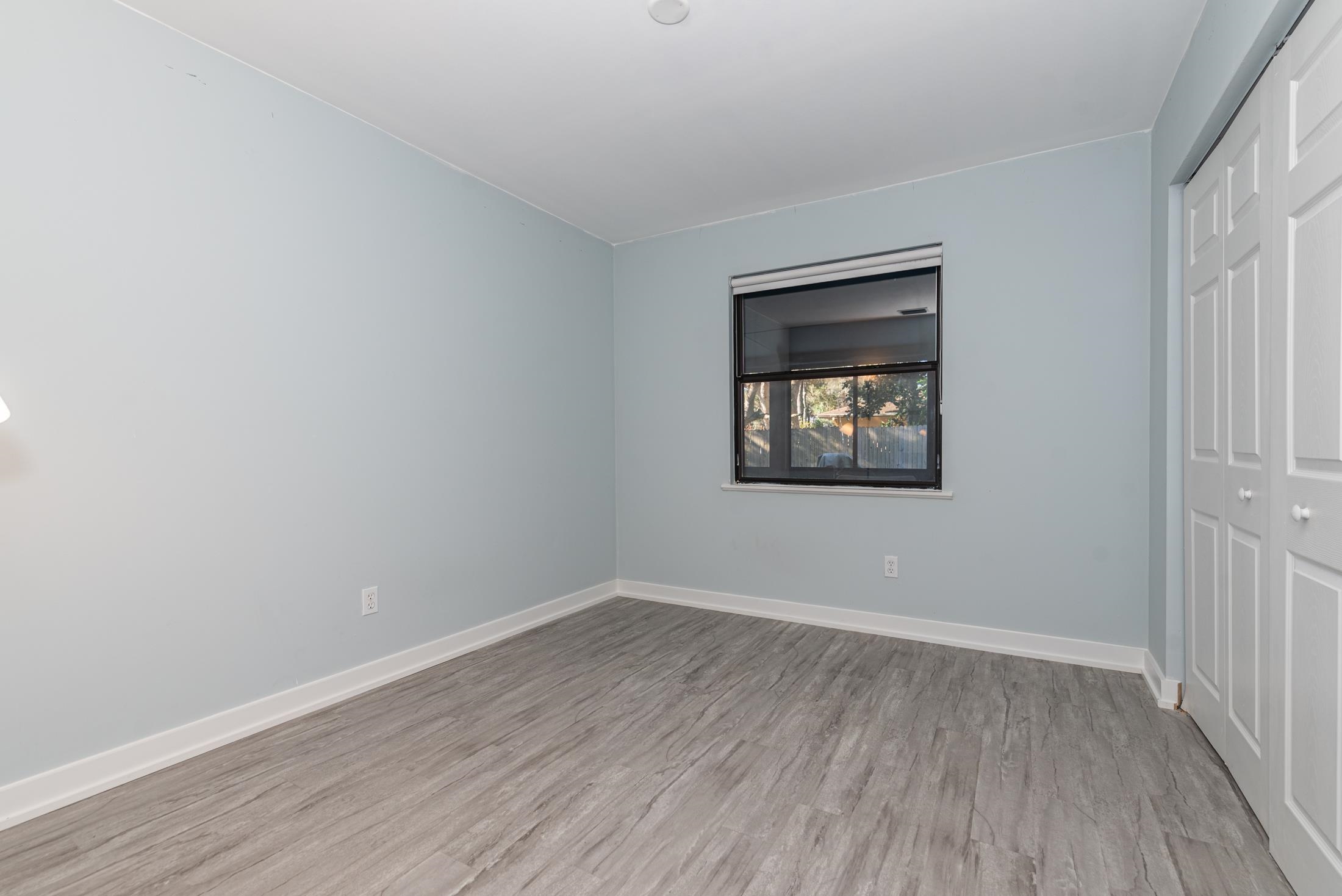 140 Orchis Road St. Augustine, FL 32086 - Photo 22 of 41 wooden floor in an empty room with a window