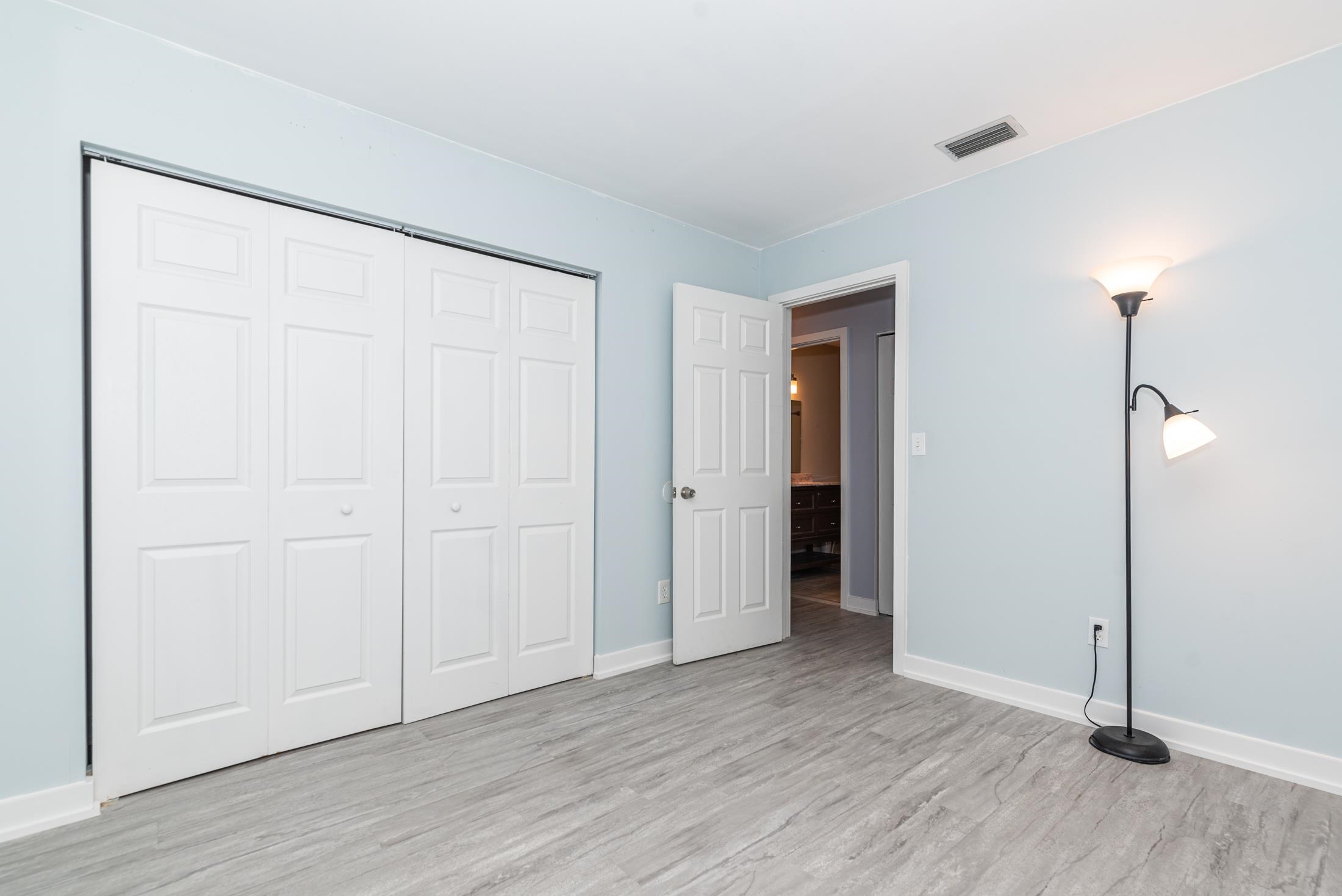 140 Orchis Road St. Augustine, FL 32086 - Photo 24 of 41 an empty room with wooden floor and closet