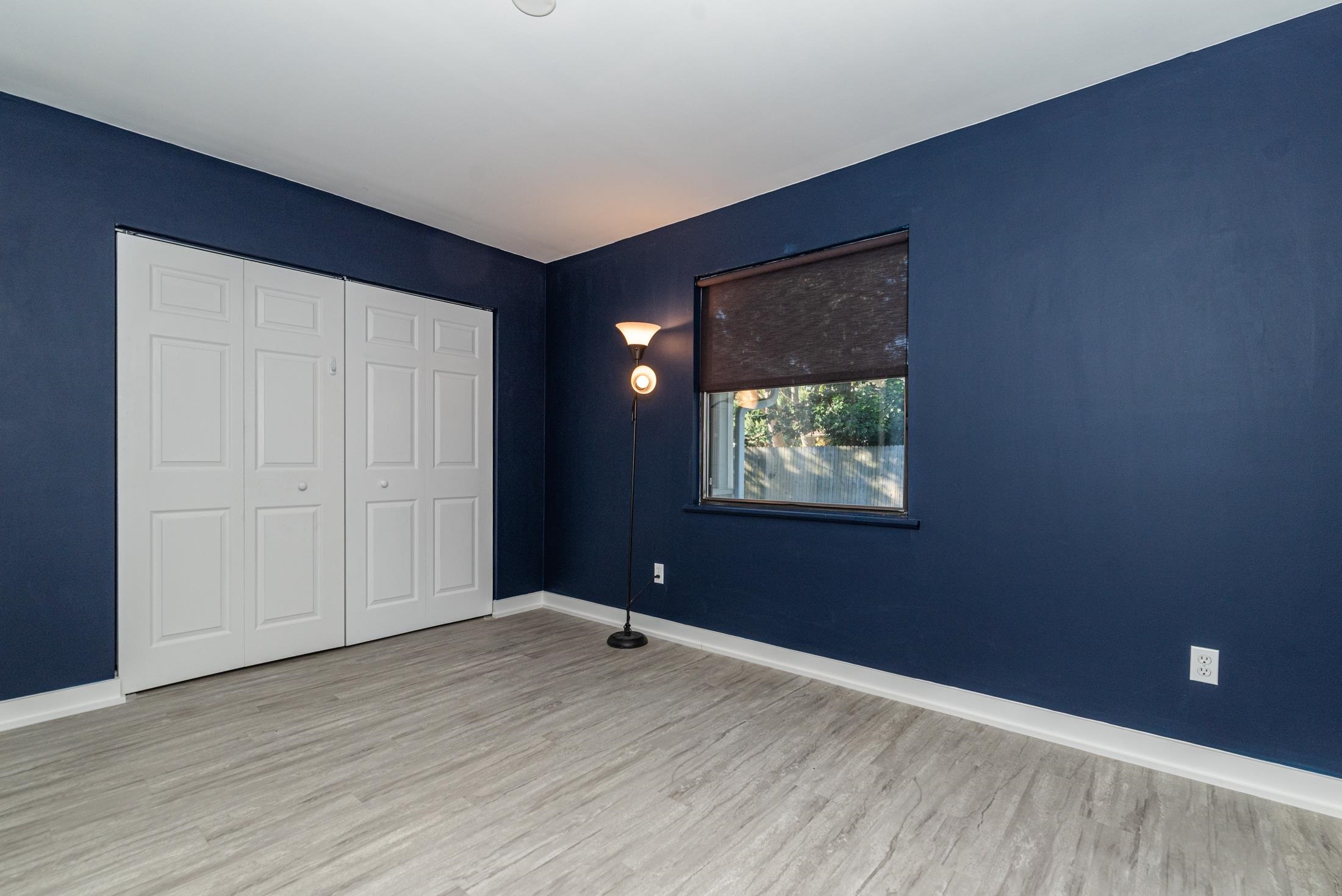 140 Orchis Road St. Augustine, FL 32086 - Photo 28 of 41 a view of an empty room with wooden floor and a window