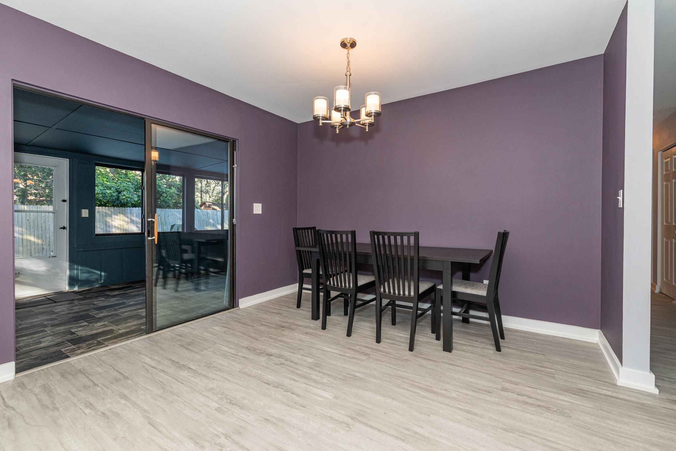 140 Orchis Road St. Augustine, FL 32086 - Photo 10 of 41 a view of a dining room with furniture wooden floor and chandelier