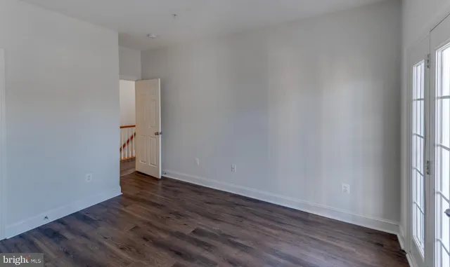 a view of an empty room and wooden floor