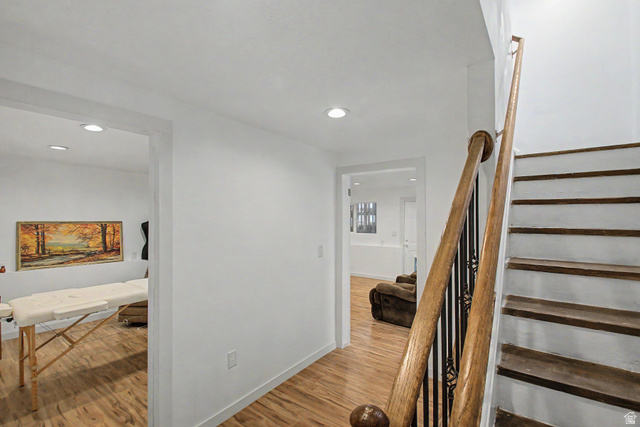 12645 East Cedar Ridge Drive Fairview, UT 84629 - Photo 22 of 34 Staircase featuring wood treads, wood handrails, and wrought iron balusters