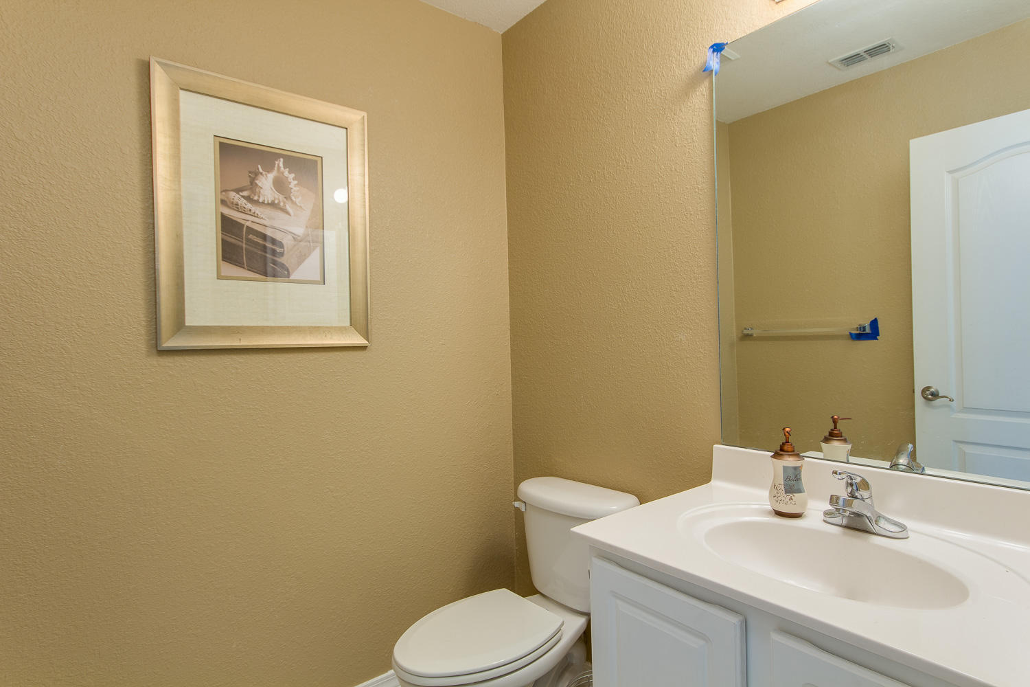 108 Red Maple Court Santa Rosa Beach, FL 32459 - Photo 6 of 30 a bathroom with a toilet sink vanity and mirror