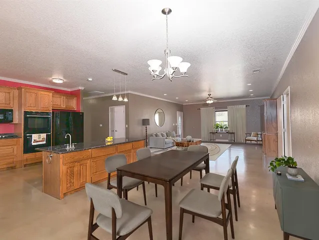 a view of a dining room with furniture and chandelier