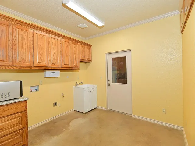a view of storage and utility room with window