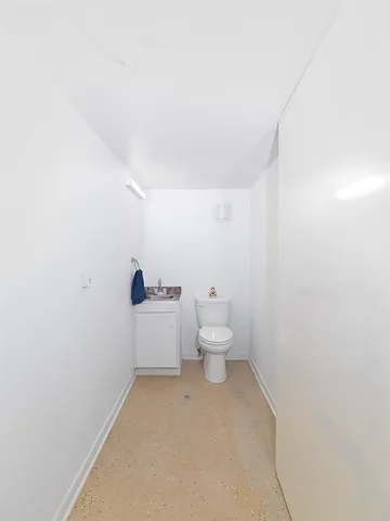 a bathroom with a white toilet and a shower