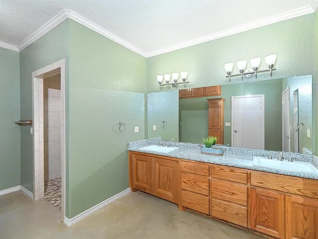 a spacious bathroom with a granite countertop sink and a mirror