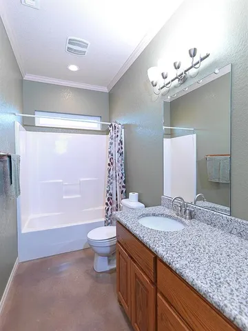 a bathroom with a granite countertop sink a toilet a mirror and shower