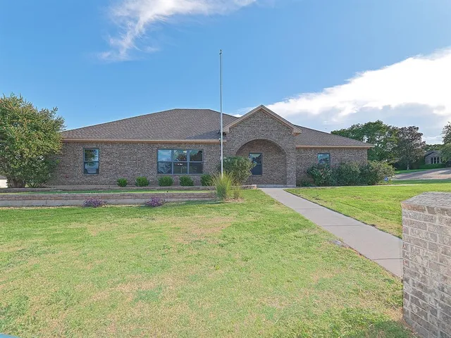 a front view of house with yard and green space