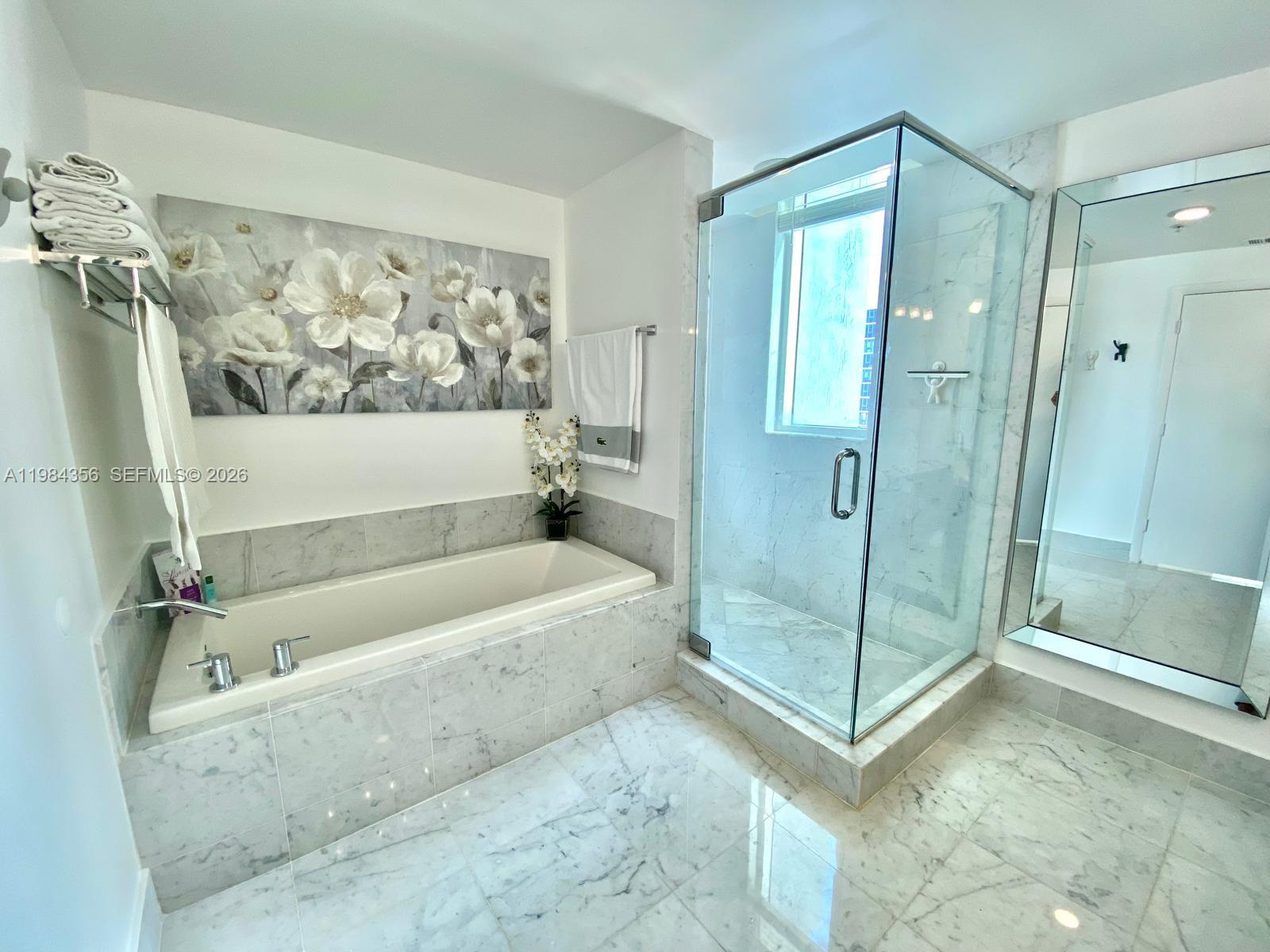 253 Northeast 2nd Street, Unit 2703 Miami, FL 33132 - Photo 17 of 33 a bathroom with a bathtub and a shower