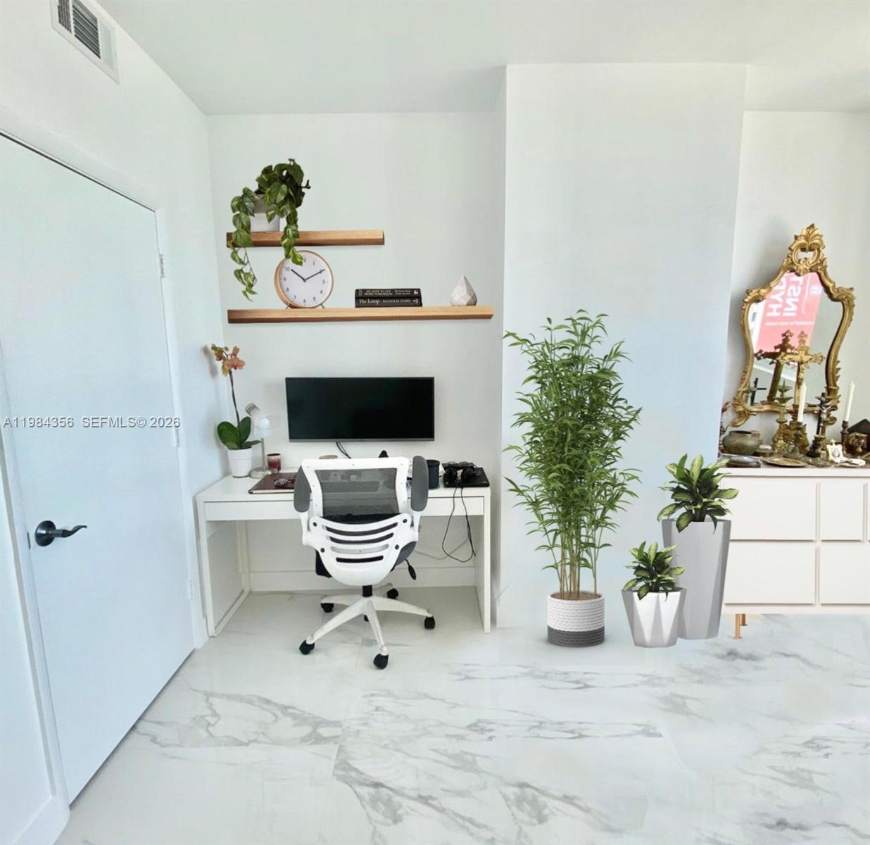 253 Northeast 2nd Street, Unit 2703 Miami, FL 33132 - Photo 20 of 33 a work room with furniture and potted plant