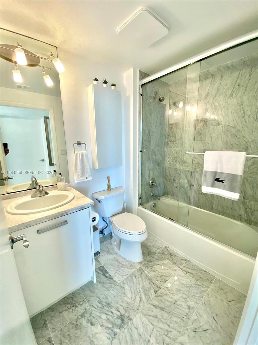 253 Northeast 2nd Street, Unit 2703 Miami, FL 33132 - Photo 21 of 33 a bathroom with a sink toilet and shower