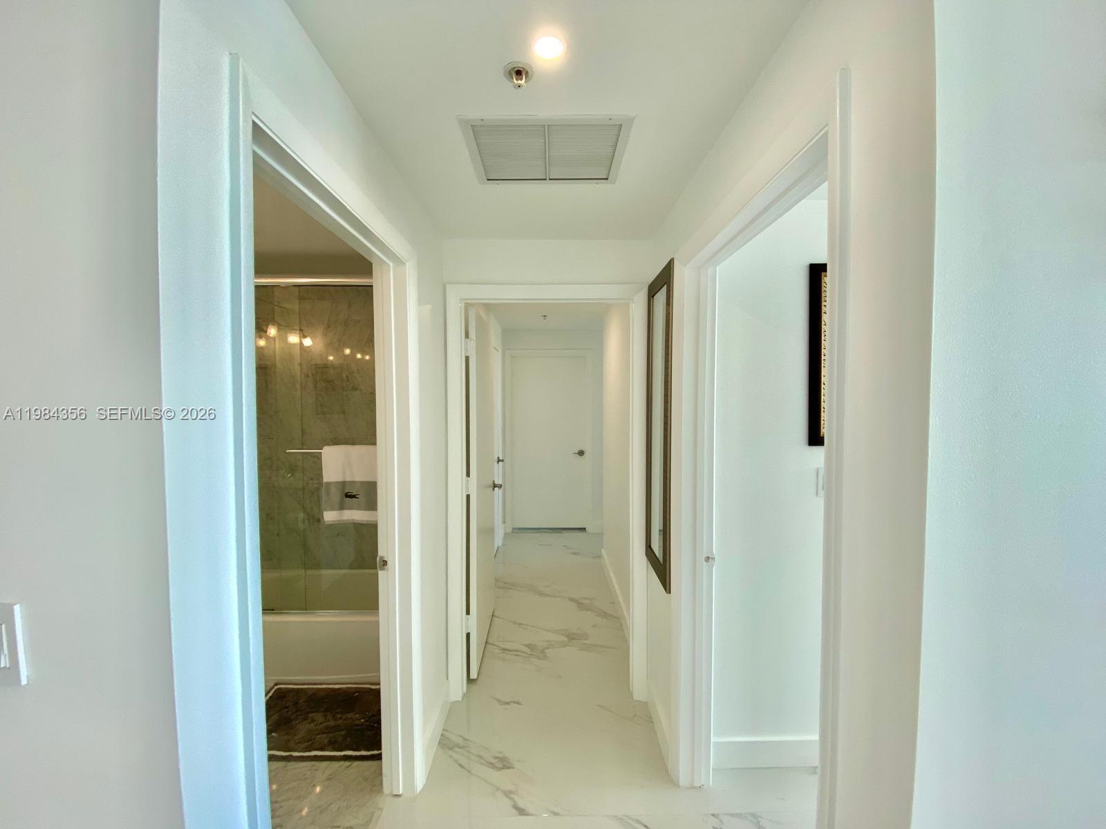 253 Northeast 2nd Street, Unit 2703 Miami, FL 33132 - Photo 25 of 33 a view of a hallway with wooden shelves