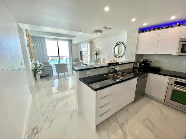 a kitchen with granite countertop a sink and a stove