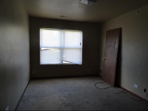 21724 Carol Avenue Sauk Village, IL 60411 - Photo 6 of 10 an empty room with a window