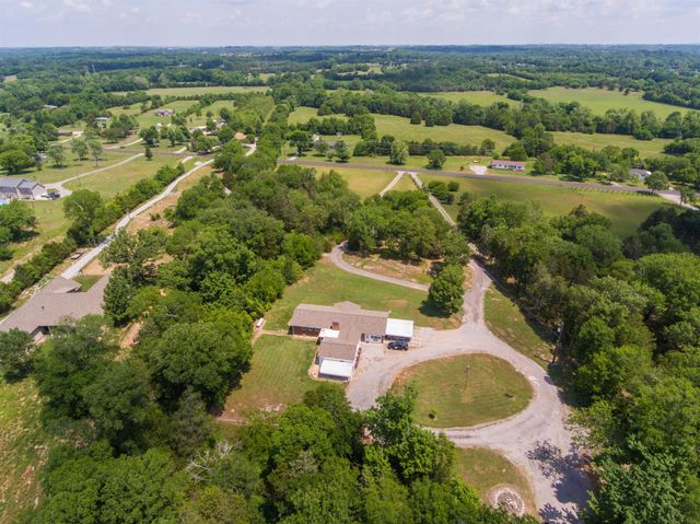 an aerial view of residential house with outdoor space and river