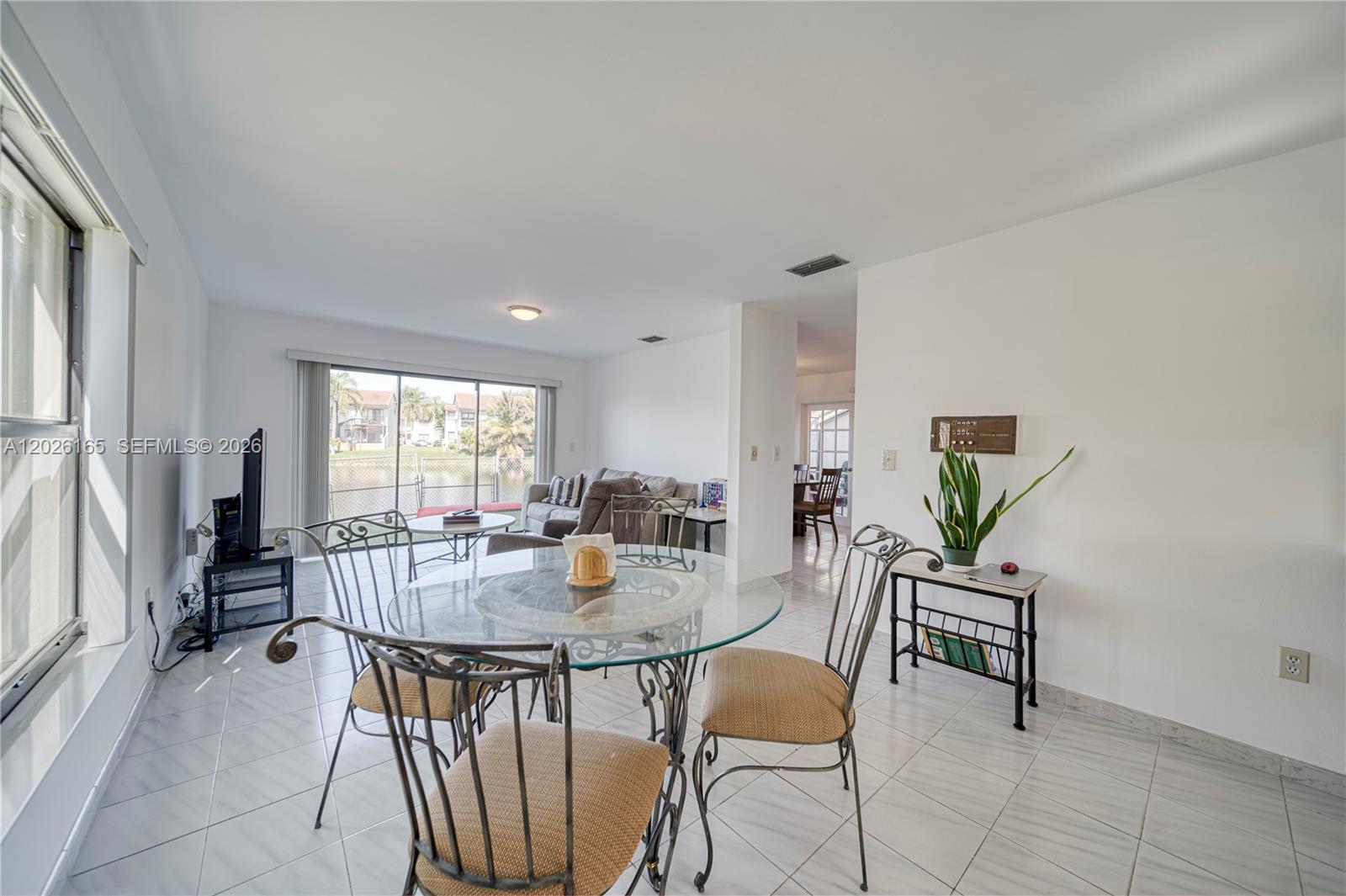 13337 Southwest 64th Lane Miami, FL 33183 - Photo 16 of 36 a view of a dining room with furniture and a potted plant