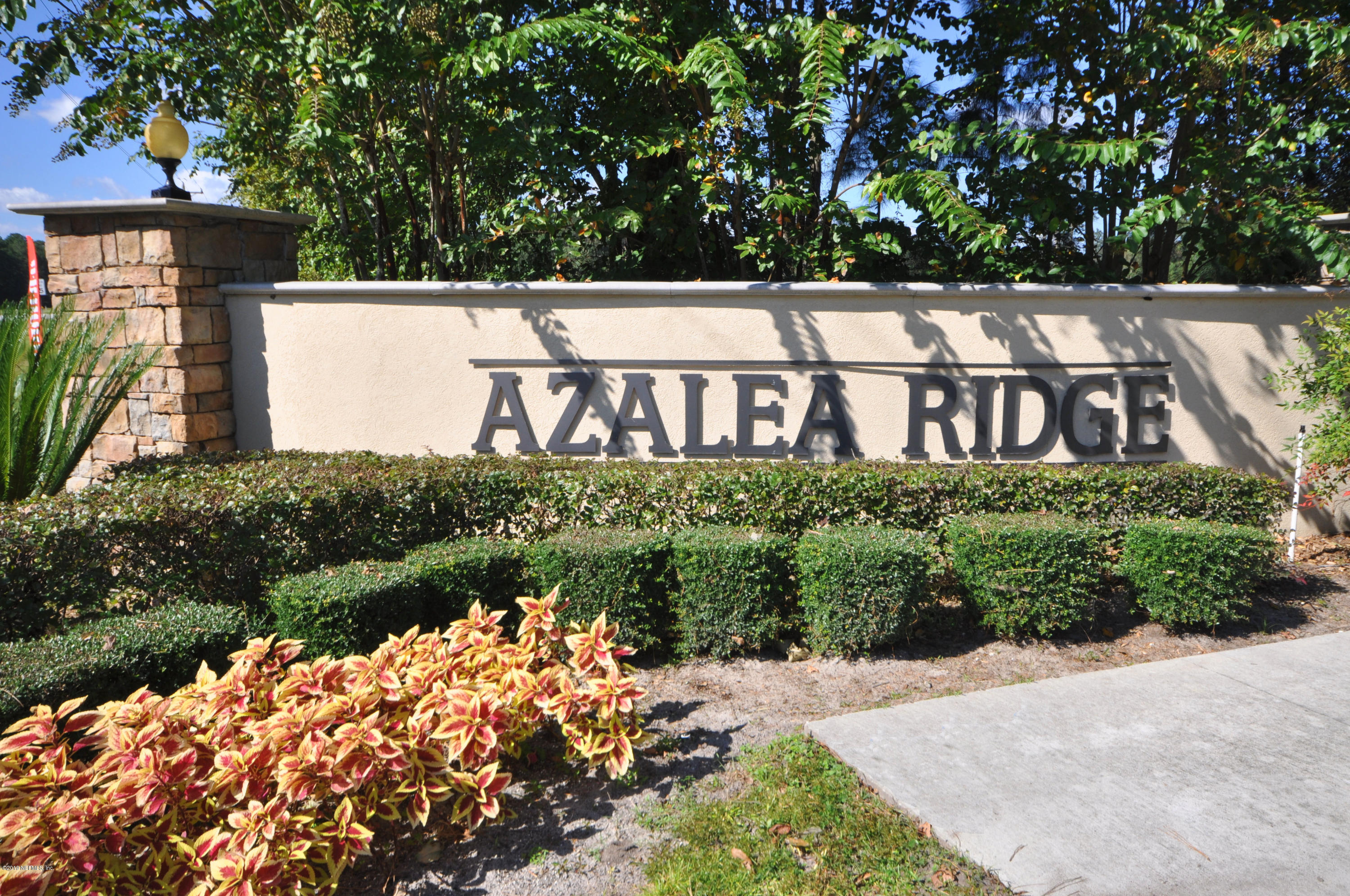 4292 Warm Springs Way Middleburg, FL 32068 - Photo 2 of 8 a view of sign board with flower around