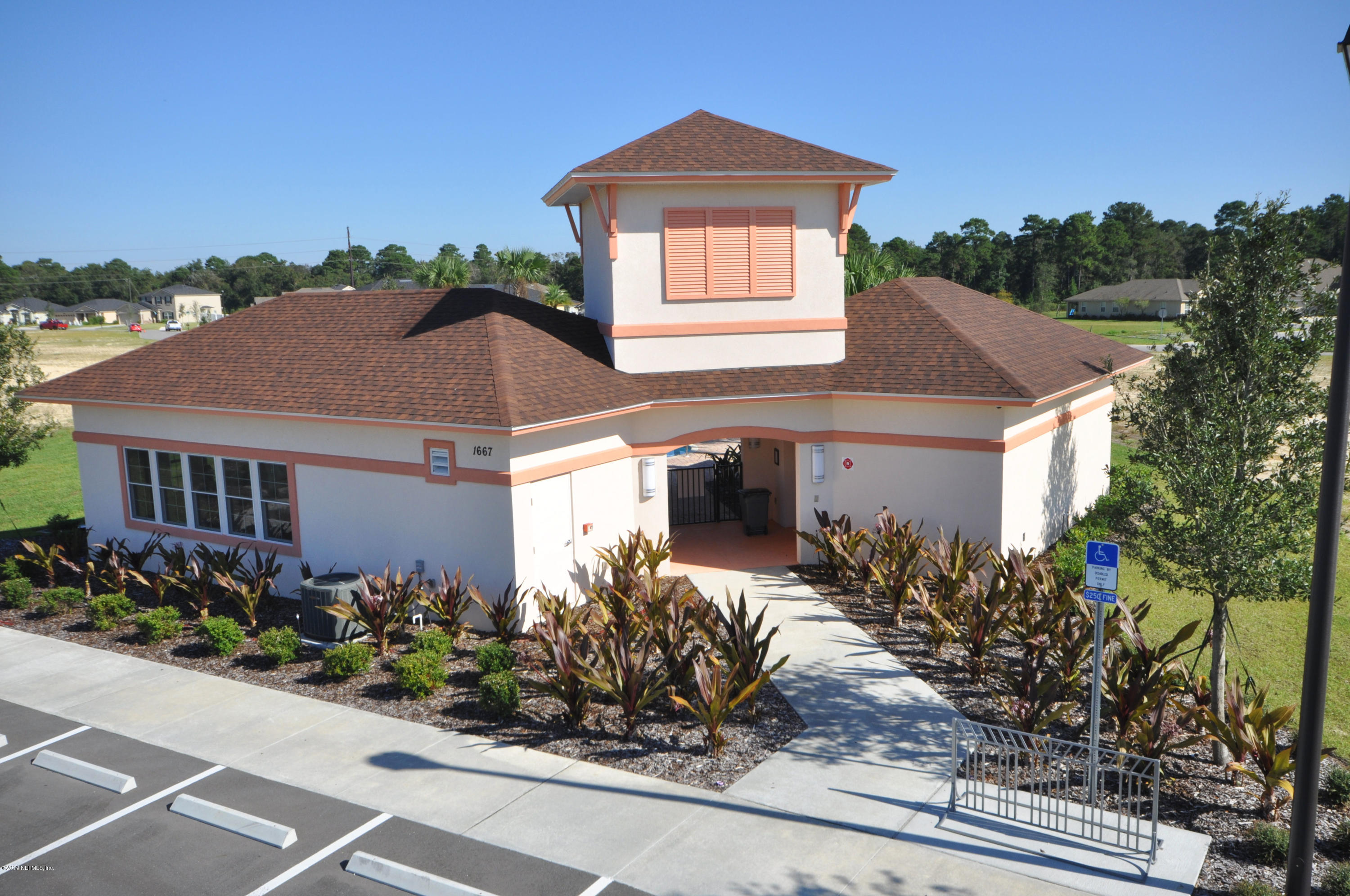 4292 Warm Springs Way Middleburg, FL 32068 - Photo 4 of 8 a front view of a house with a yard and potted plants