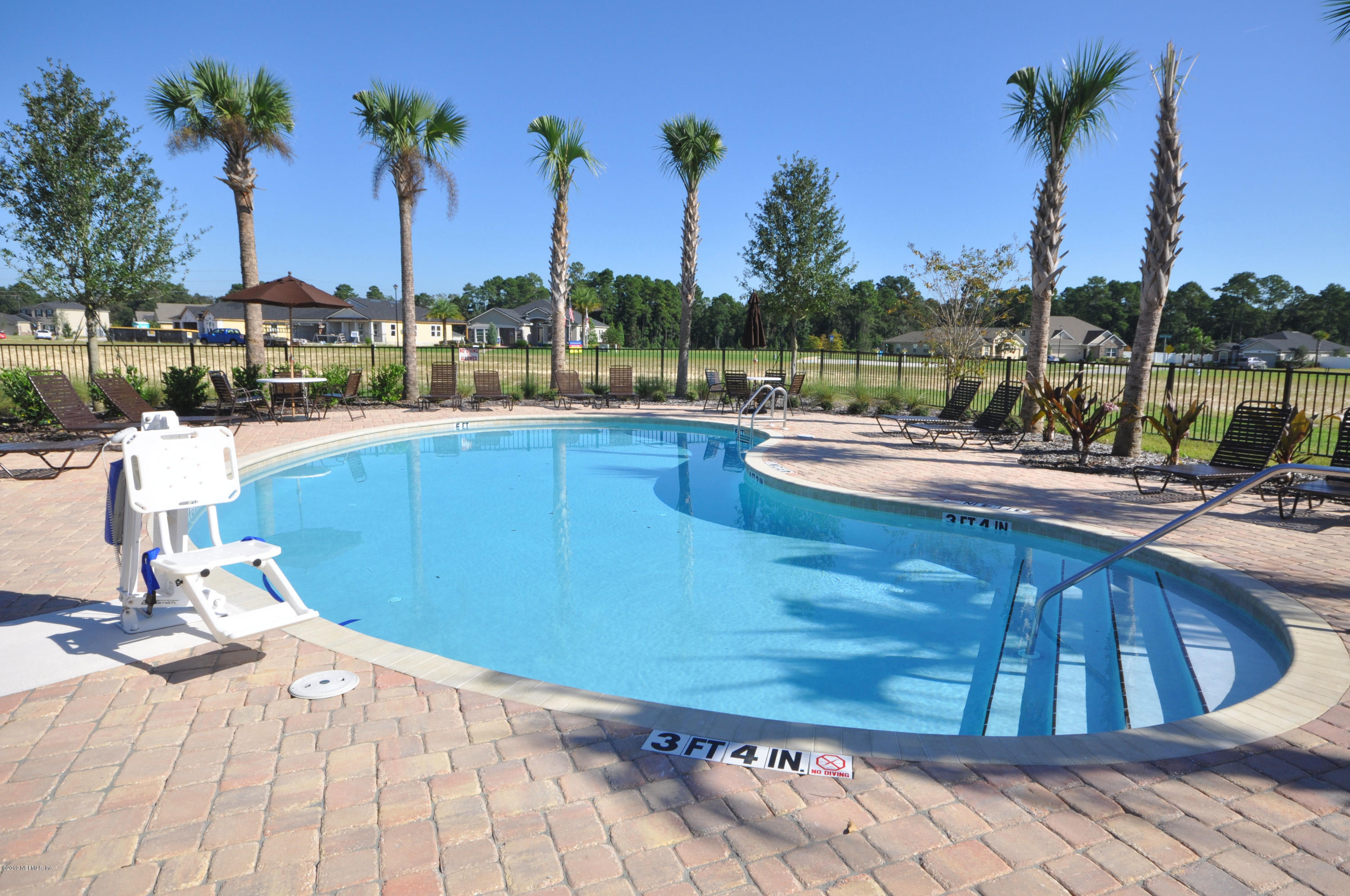 4292 Warm Springs Way Middleburg, FL 32068 - Photo 5 of 8 a view of a swimming pool with a lounge chairs