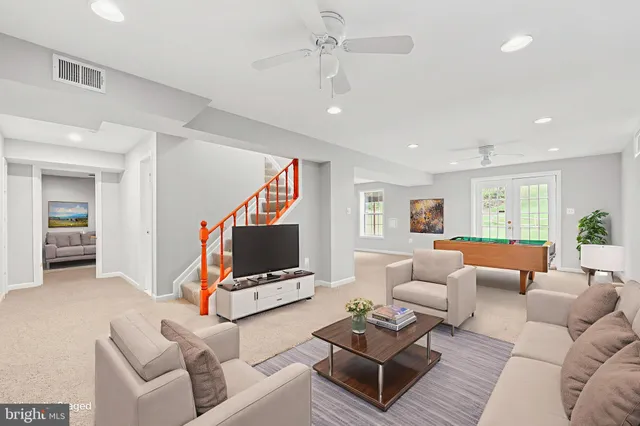 a view of a patio with couches table and chairs and potted plants