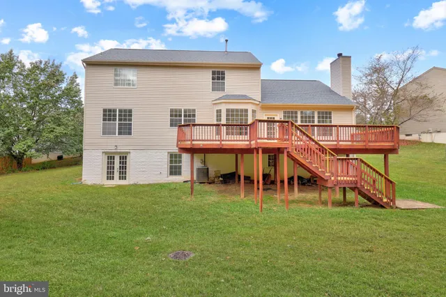 an aerial view of a house with garden space and swimming pool
