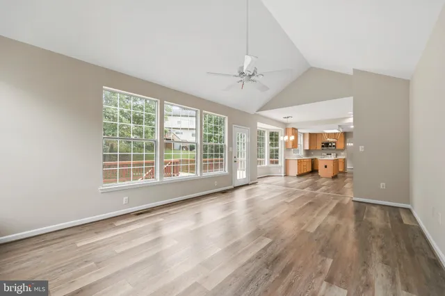 a view of an empty room with a fireplace and a window