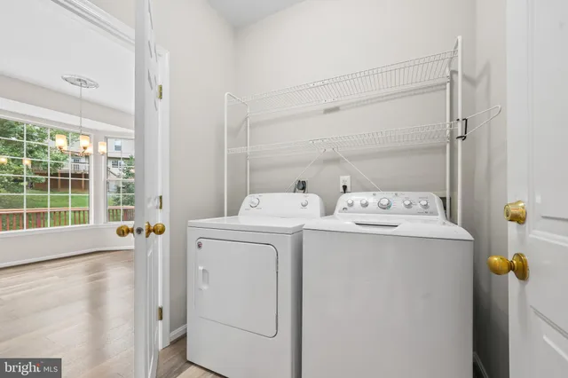 a view of a room with wooden floor and window