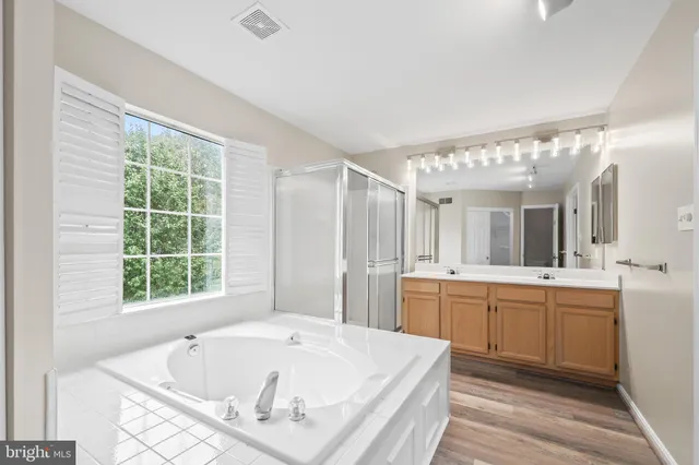 a view of a big room with windows and chandelier fan