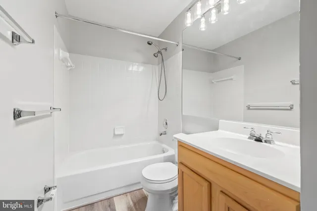 a bathroom with a sink toilet vanity and shower