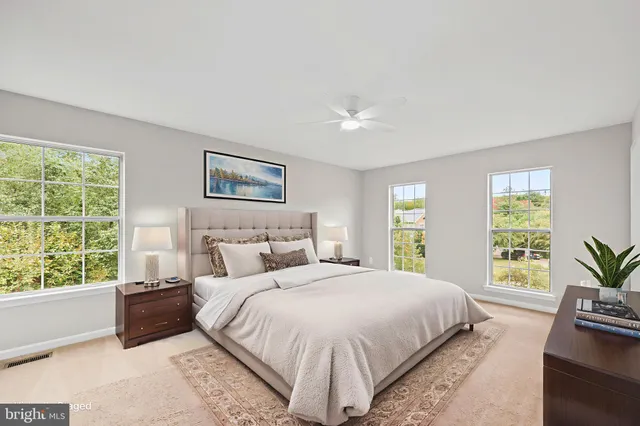 a bedroom with a large bed and a couch