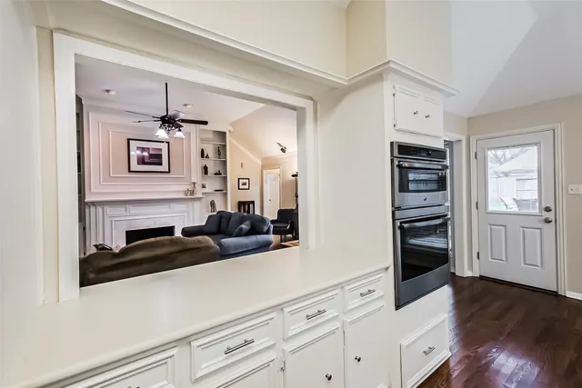 a kitchen with cabinets and wooden floor
