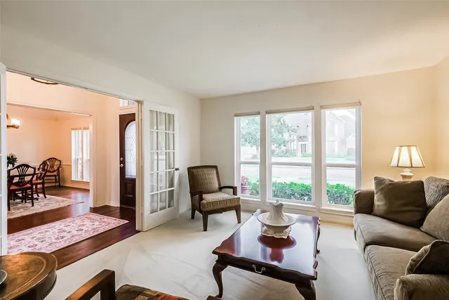 a living room with furniture and floor to ceiling window