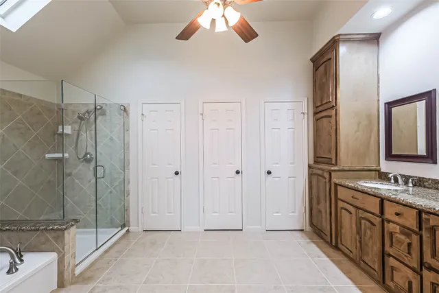a bathroom with a shower sink and mirror