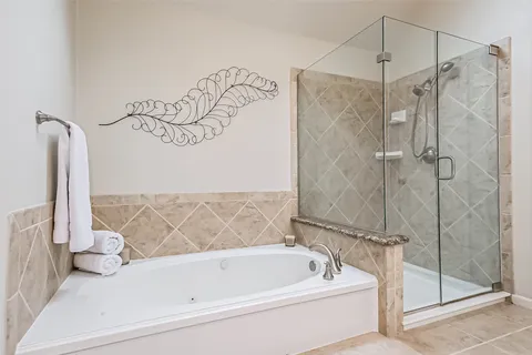 a bathroom with a bathtub and shower