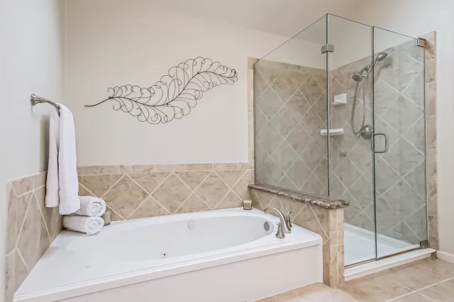 a bathroom with a bathtub and shower