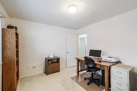 a view of workspace with furniture and closet