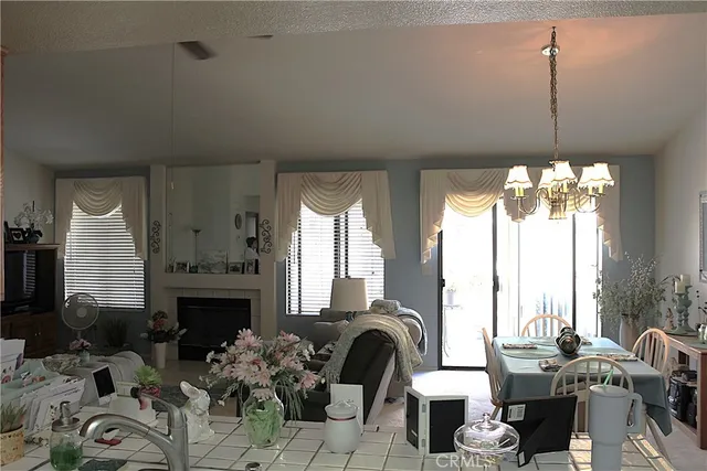 a living room with furniture fireplace and a large window