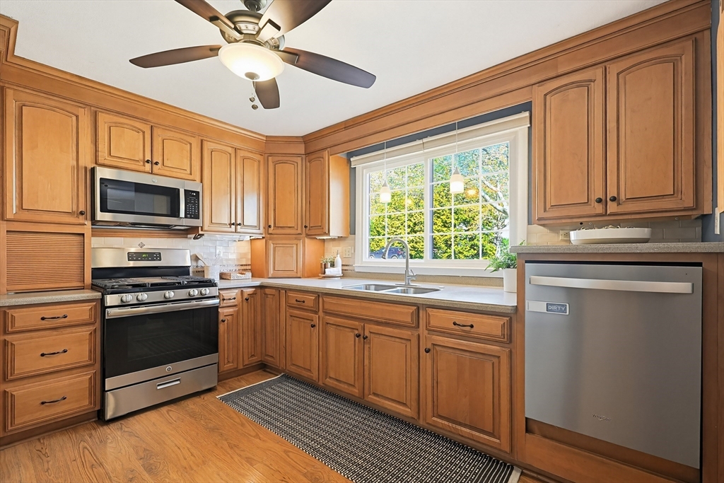 18 Anchorage Road Franklin, MA 02038 - Photo 10 of 42 a kitchen with stainless steel appliances granite countertop a stove sink and microwave